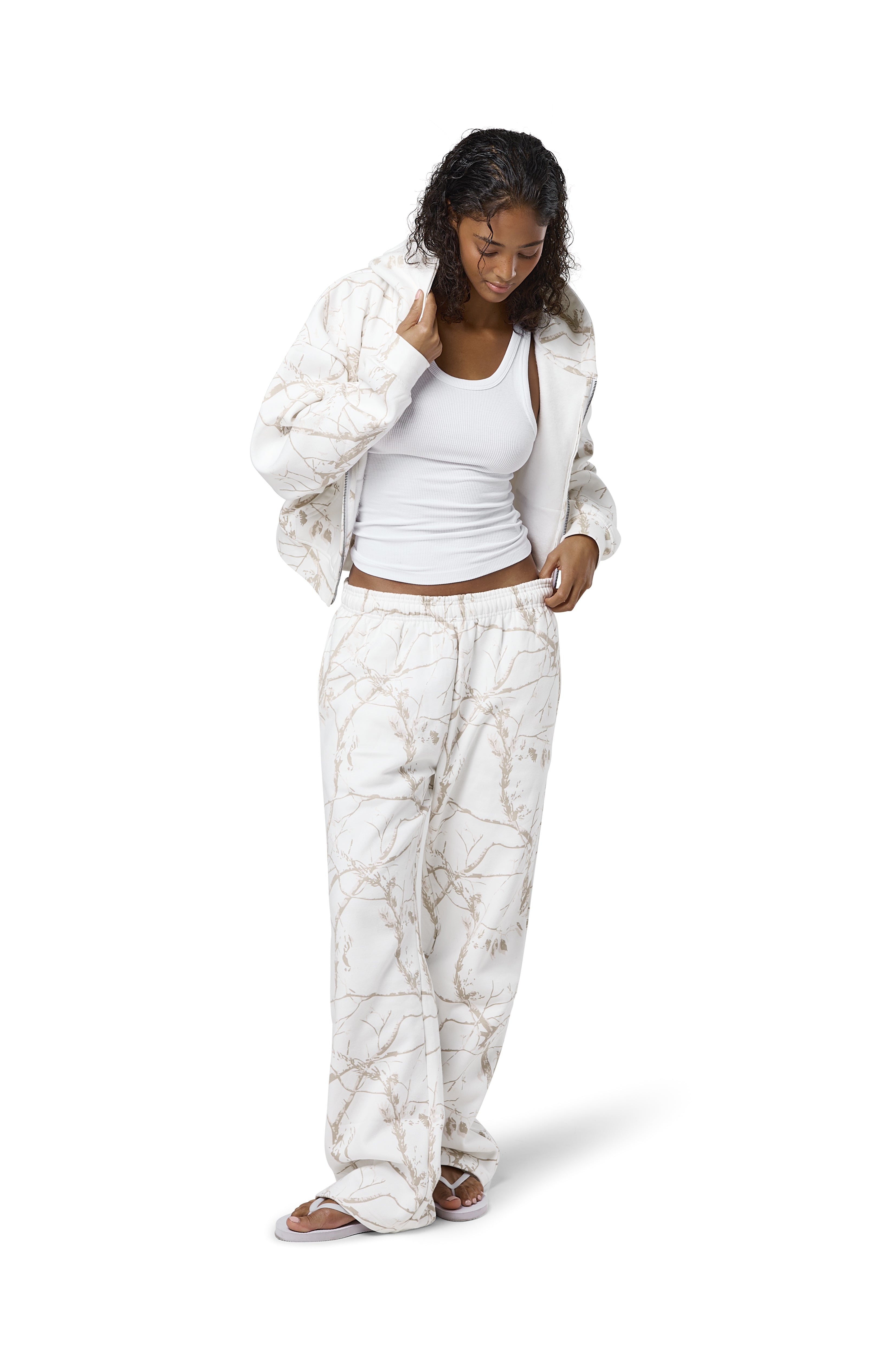 Off-white camouflage print sweatpants in a 'milk' shade, featuring a subtle twig pattern, available in petite, regular, and tall sizes.